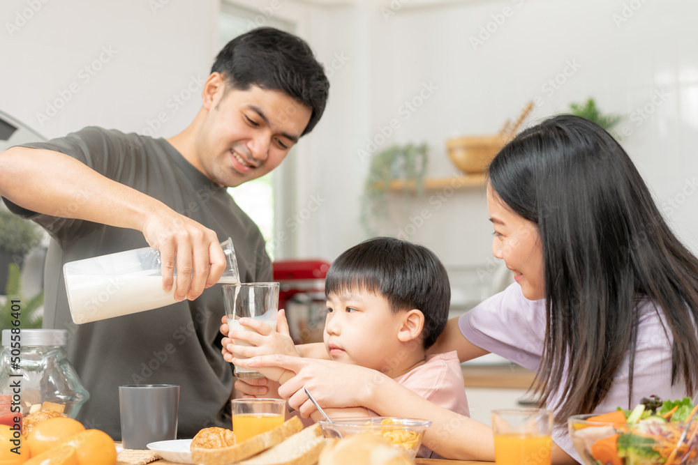 Happy refreshment family breakfast in morning, asian young parent father, mother and little cute boy, child having meal in kitchen eating together at home. Cheerful, enjoy cooking people. Happy refreshment family breakfast in morning, asian young parent father, mother and little cute boy, child having meal in kitchen eating together at home. Cheerful, enjoy cooking people.