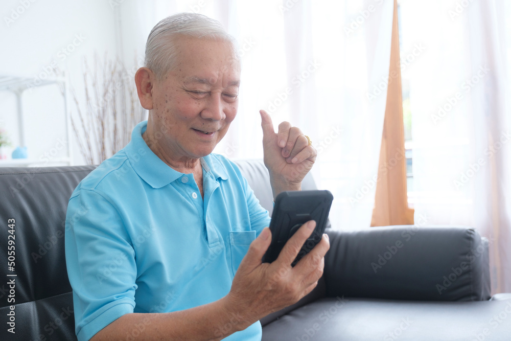 Elderly man making video call and waving at screen. Elderly man making video call and waving at screen.