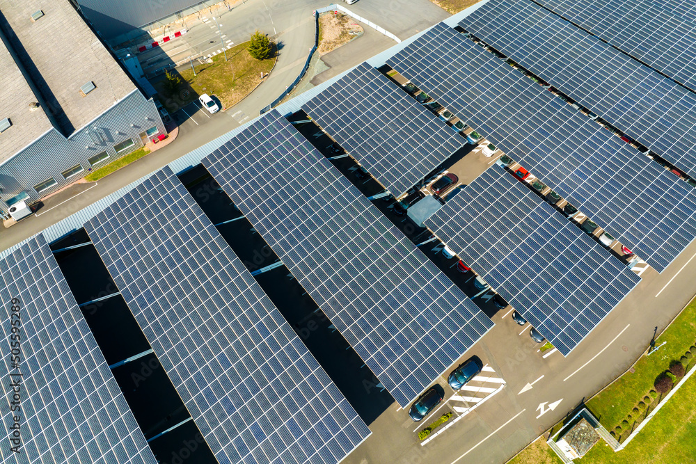 Aerial view of solar panels installed over parking lot with parked cars for effective generation of clean energy - obrazy, fototapety, plakaty 