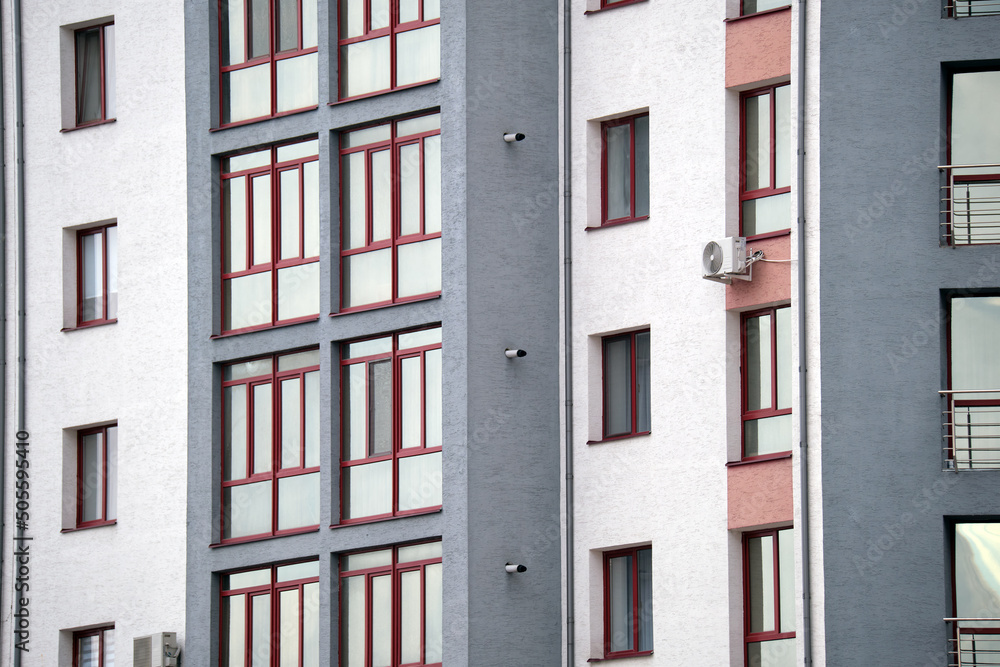 Architectural details of modern high apartment building facade with many windows and balconies Architectural details of modern high apartment building facade with many windows and balconies