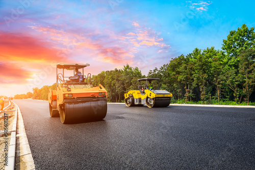 Construction site is laying new asphalt pavement. road construction workers and road construction machinery scene. Highway construction site scene in China.