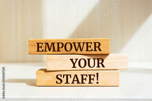 Wooden blocks with words 'Empower your staff'.