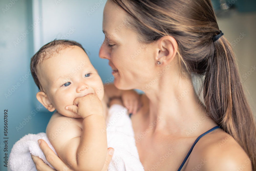 Mother holding her cute baby toddler after giving her a bath. Parenting, and family lifestyle. Mother holding her cute baby toddler after giving her a bath. Parenting, and family lifestyle.
