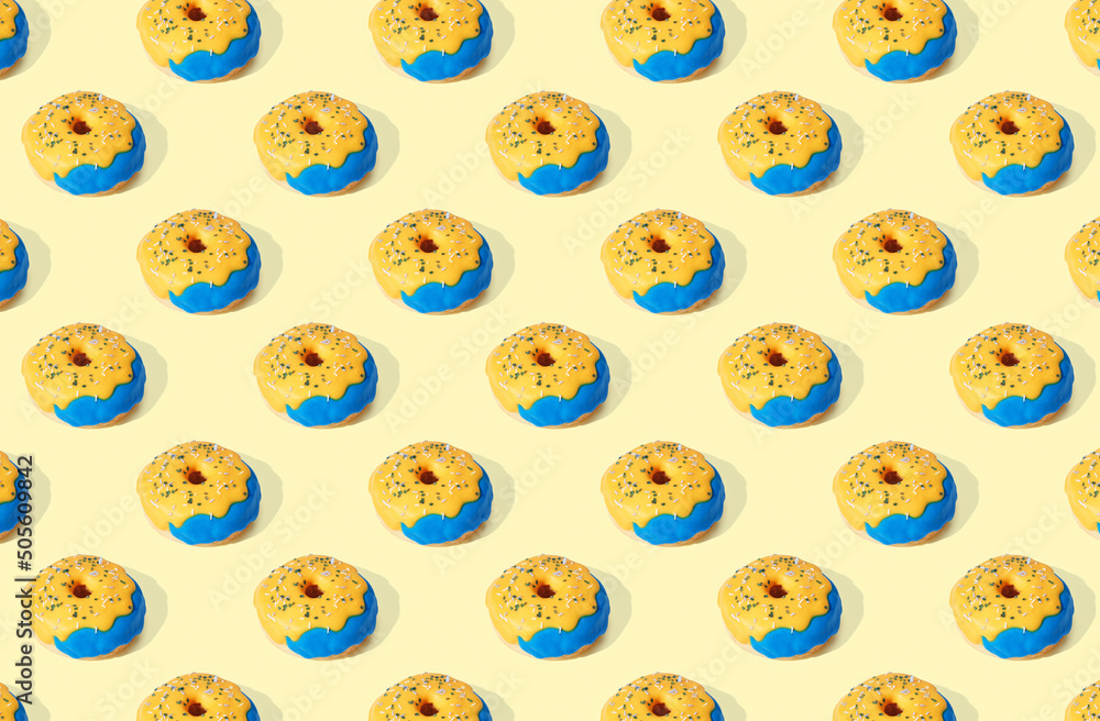 Pattern of donuts on yellow pastel background Pattern of donuts on yellow pastel background