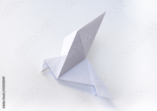 Paper dove origami isolated on a white background