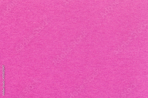 Texture of light purple and lilac colors paper background, macro. Structure of dense magenta craft cardboard.