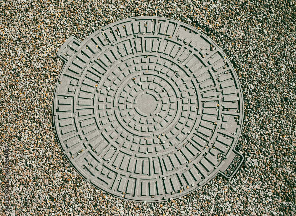 Sewer manhole in the city as a background