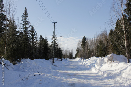 A snow-covered highway in Ugra. A highway outside the city in the North. Snow on the roadsides and frost