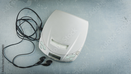 Close up of a vintage portable compact disc player on metal background.