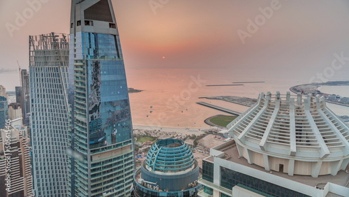 Aerial sunset view of JBR and Dubai Marina skyscrapers and luxury buildings timelapse from above © neiezhmakov
