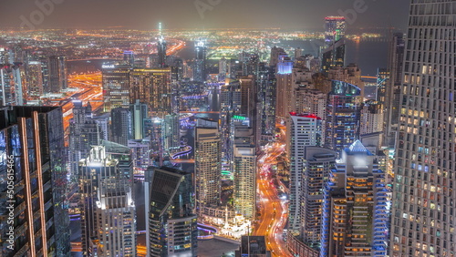 View of Dubai Marina showing canal surrounded by skyscrapers along shoreline night timelapse. DUBAI, UAE