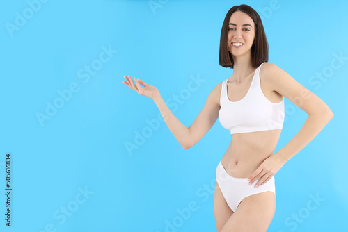 Concept of weight loss with thin girl on blue background