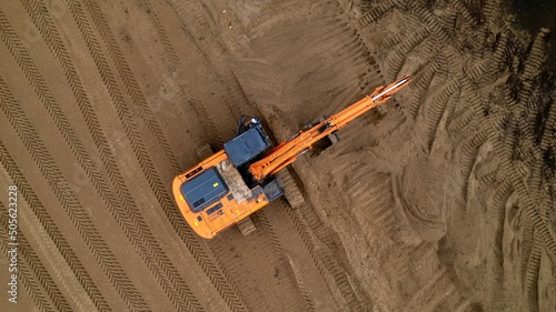 Aerial view of the excavator. The excavator prepares the road from sand for laying asphalt. photo