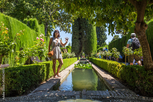 A woman in the beautiful gardens of the Generalife, Alhambra, Granda