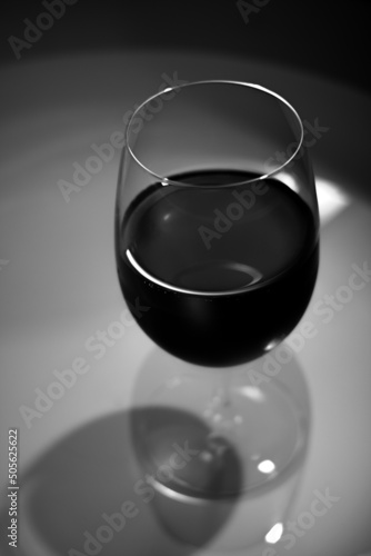 Low key image of red wine in black and white.