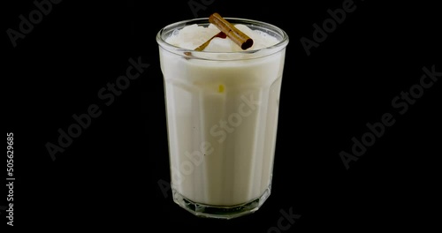 Orchata water with cinnamon on a turntable. Mexican drink. photo