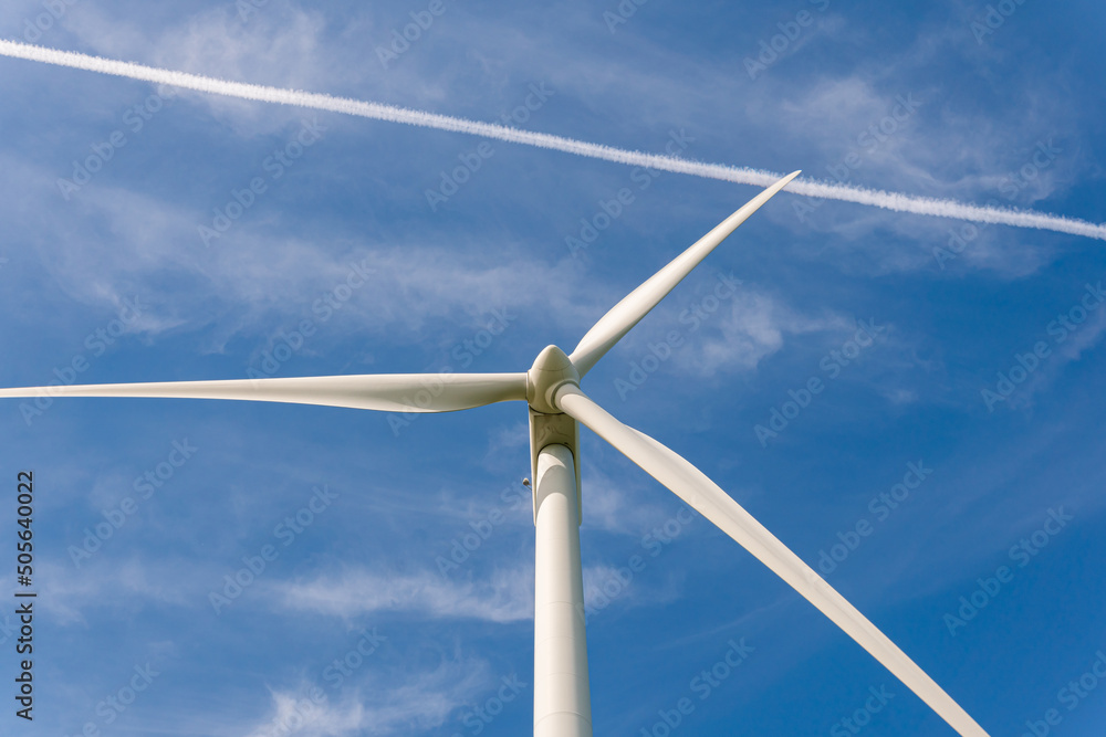 Sweden, Kristianstad – May 17, 2022: Huge wind turbines, electrical energy generators in a field outdoors, blue sky. Sweden, Kristianstad – May 17, 2022: Huge wind turbines, electrical energy generators in a field outdoors, blue sky.