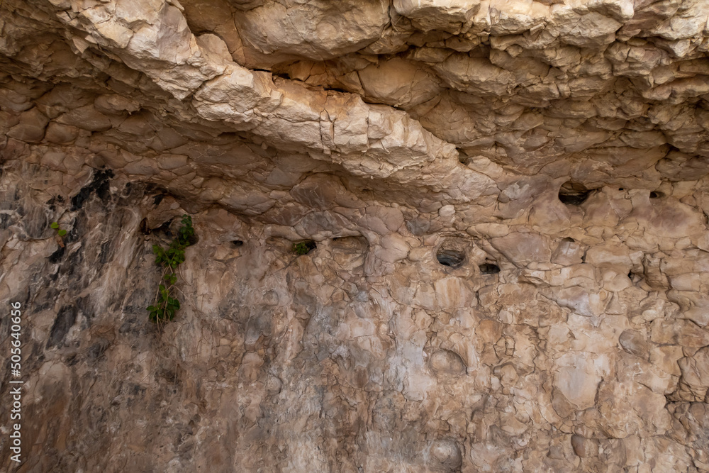 Fototapeta premium Places for lamps in the remains of the buildings of the ancient settlement on Mount Arbel, located on the coast of Lake Kinneret - the Sea of Galilee, near the city of Tiberias, in northern Israel