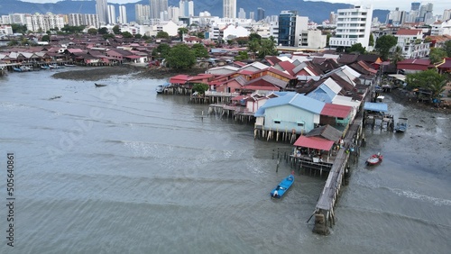 Georgetown, Penang Malaysia - May 13, 2022: The Clan Jetties of Georgetown Penang, Malaysia. Wooden villages built on stilts at the sea coast by the different clans of the Penang Chinese community. photo