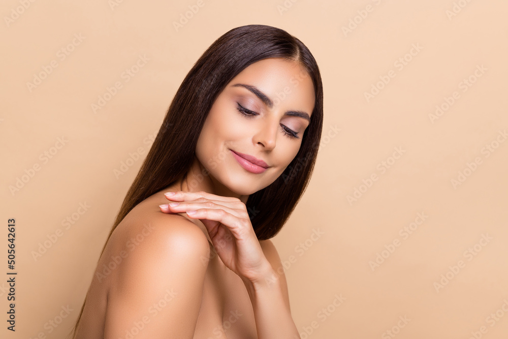 Profile side view portrait of attractive cheery dreamy girl touching flawless soft skin isolated over beige pastel color background Profile side view portrait of attractive cheery dreamy girl touching flawless soft skin isolated over beige pastel color background
