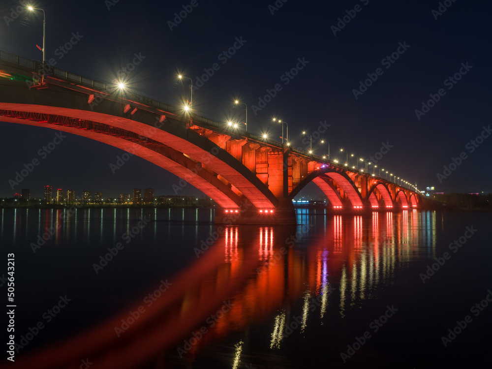 Siberian city of Krasnoyarsk. Night view of the Yenisei River. Communal bridge