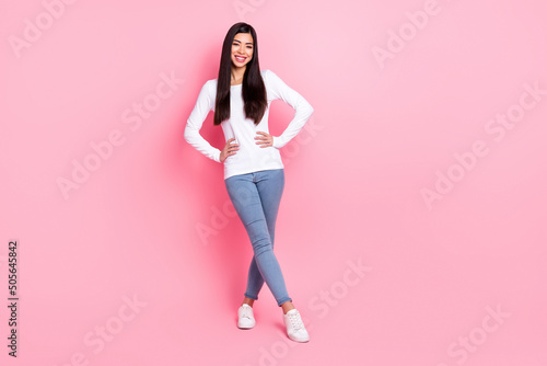 Full size photo of nice millennial brunette lady stand wear shirt jeans shoes isolated on pink color background