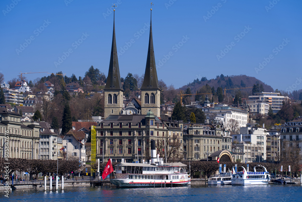 City of Luzern with twin towers of catholic Hofkirche St. Leodegar (Court Church) on a sunny spring day. Photo taken March 23rd, 2022, Lucerne, Switzerland.