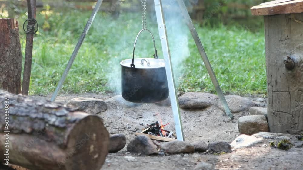 Cooking food in nature. The pot is hanging over the fire, no people 4K Cooking food in nature. The pot is hanging over the fire, no people 4K