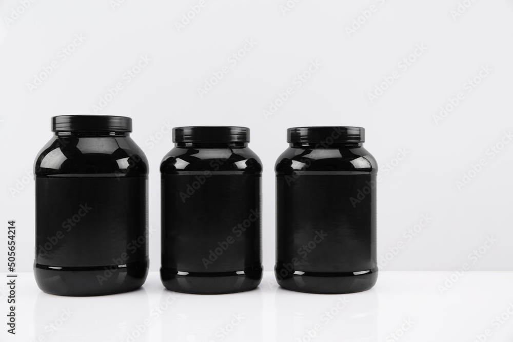 black jars side by side on white background black jars side by side on white background