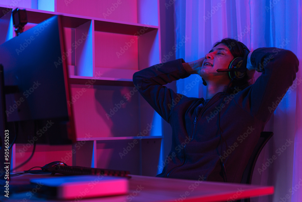 Game stream concept, Male streamer taking a break to rest after live streaming of game tournament Game stream concept, Male streamer taking a break to rest after live streaming of game tournament