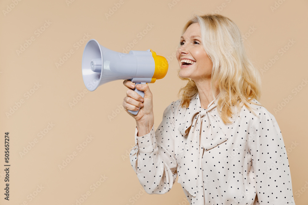Φωτογραφία Excited happy elderly gray-haired blonde woman lady 40s years old wears pink dress hold scream in megaphone announces discounts sale Hurry up isolated on plain pastel beige background studio portrait