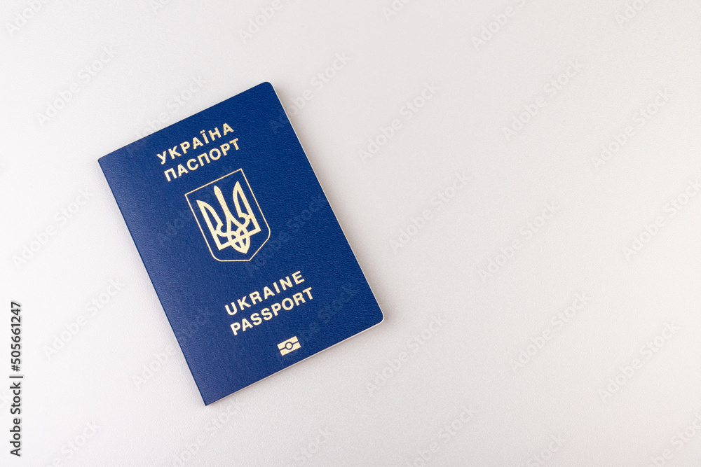 Ukrainian passport with a golden trident symbol on light background. Biometric Ukraine passport id empty place for photo or text. Ukrainian passport with a golden trident symbol on light background. Biometric Ukraine passport id empty place for photo or text.