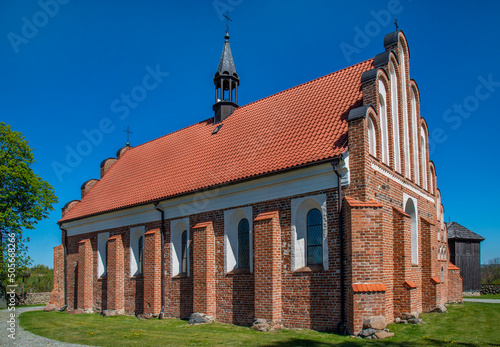 A general view of the wooden belfry built in the mid-16th century and the brick Catholic church of Saint Stanislaus in the town of Niedzwiadna in Mazovia, Poland.