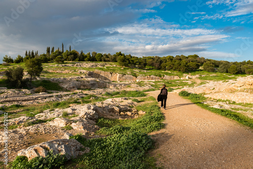 Athens Old Town, Attica, Greece - Active young woman hiking down the green hills of Muses, Nymphs and Philopappos photo