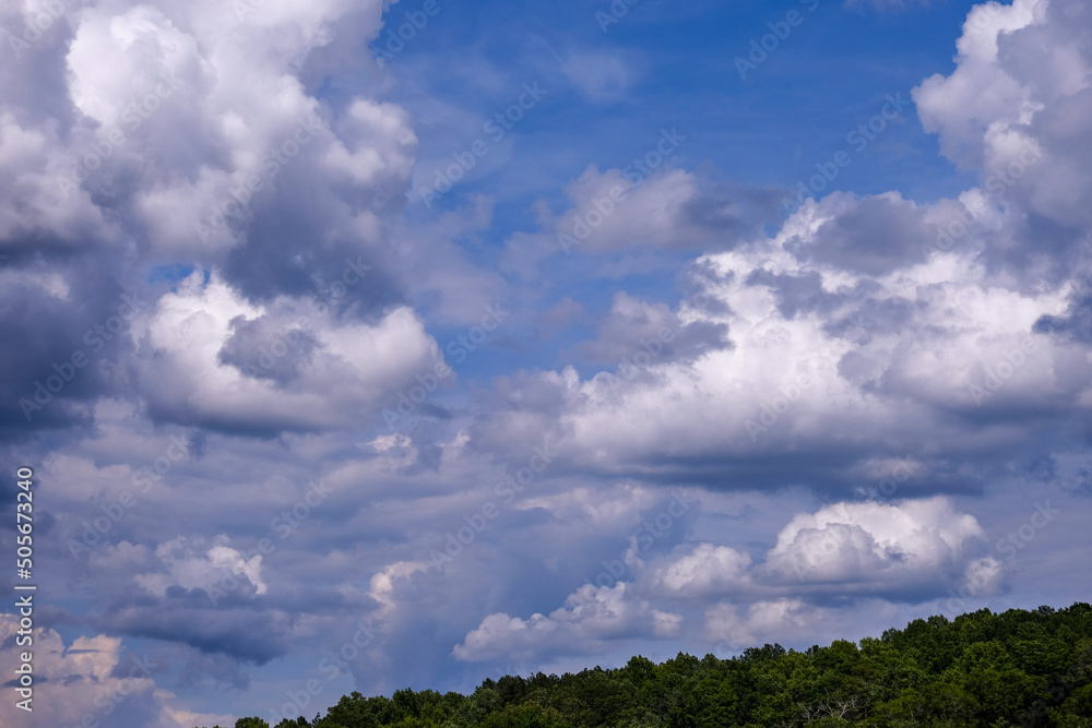 Dramatic fluffy cloudscape and deep blue sky