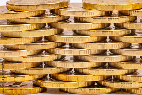 Money background. Stacks of gold coins in staggered order, close-up