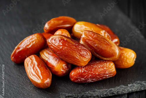 juicy royal dates on a black wooden rustic background