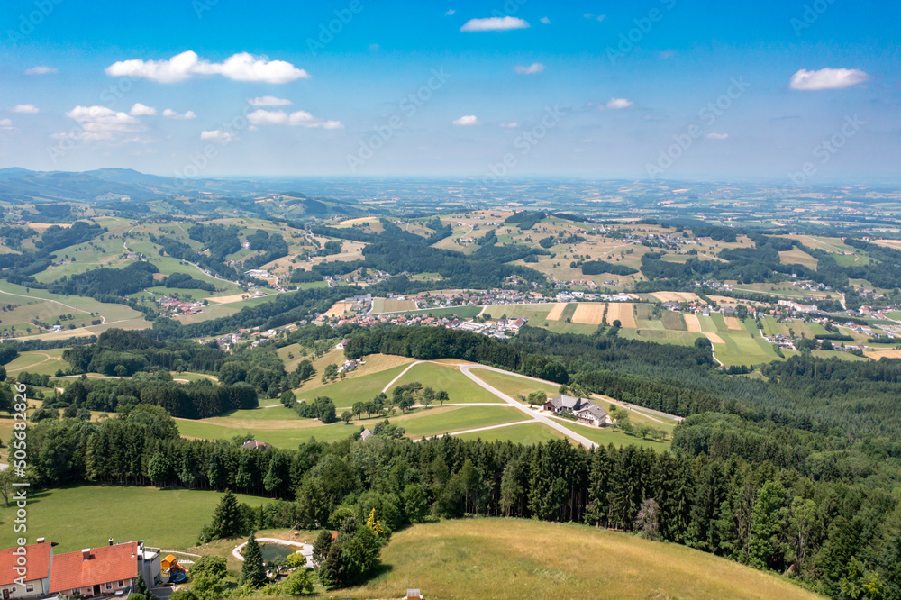 Drone view of a landscape in Austria. Panorama among fields and alpine mountains in Tyrol, Dolomites