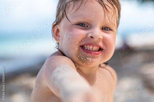 Fotografija A little girl on a sandy beach