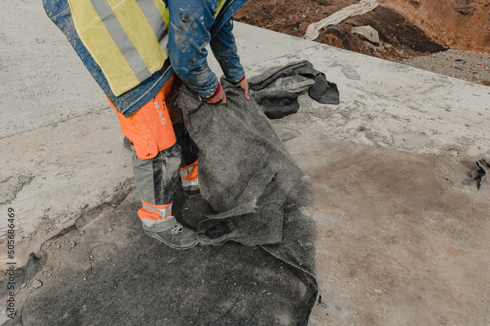 Construction worker doing concrete laying Construction worker doing concrete laying