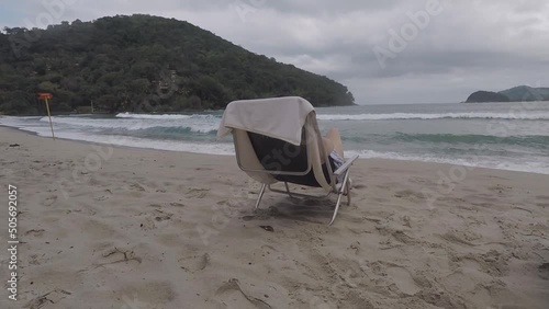 Barra do Sahy, São Sebastião, São Paulo, Brazil, May 13, 2022. Looking at the sea sitting on the beach chair