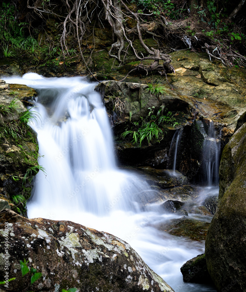 Little Hawaii Waterfall with silky water flow taken at Wilson hiking trail in Hong Kong with long exposure technique Little Hawaii Waterfall with silky water flow taken at Wilson hiking trail in Hong Kong with long exposure technique