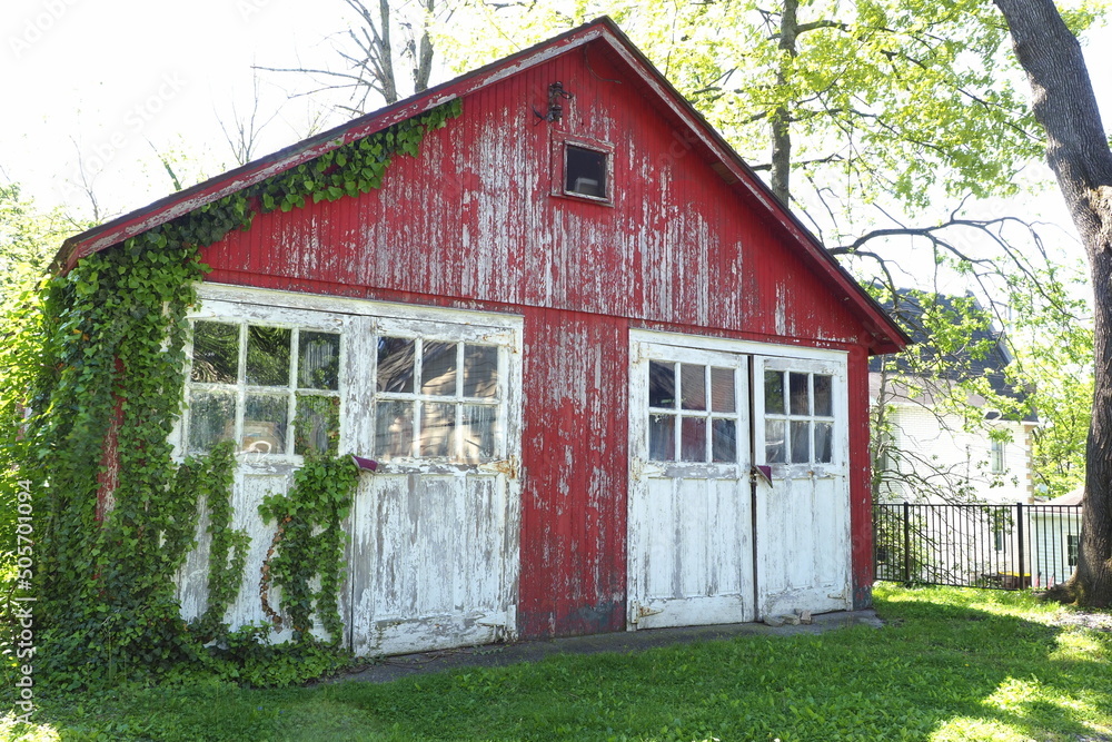 This ld 2 car garage has weathered and needs to be painted. Both the red and white paint are fading. This ld 2 car garage has weathered and needs to be painted. Both the red and white paint are fading.