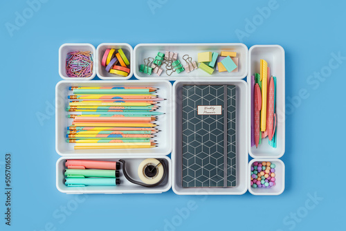 Stylish colored school stationery is arranged in organizers. Creative Drawer Organizing. Storage office supplies. Concept back to school.