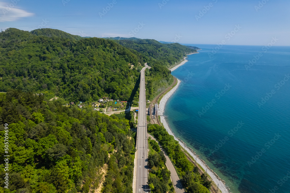 The Zubova Schel Viaduct is a road bridge, Dzhubga - Adler federal road. Aerial view of car driving along the winding mountain road in Sochi, Russia. The Zubova Schel Viaduct is a road bridge, Dzhubga - Adler federal road. Aerial view of car driving along the winding mountain road in Sochi, Russia.