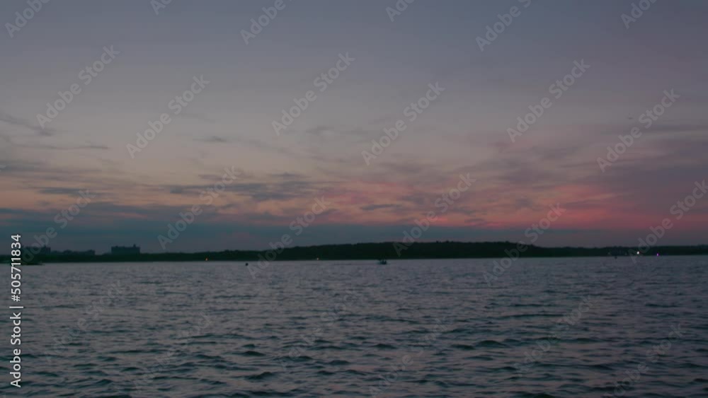 Slow-mo at Hart Island, Solemn burial site for unidentified dead, from the water, sunset in the evening. Wide shot Slow-mo at Hart Island, Solemn burial site for unidentified dead, from the water, sunset in the evening. Wide shot