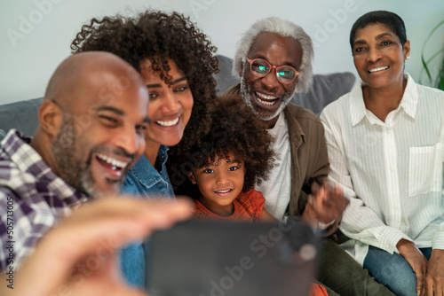 Happy family taking selfie at home © PhotoAlto