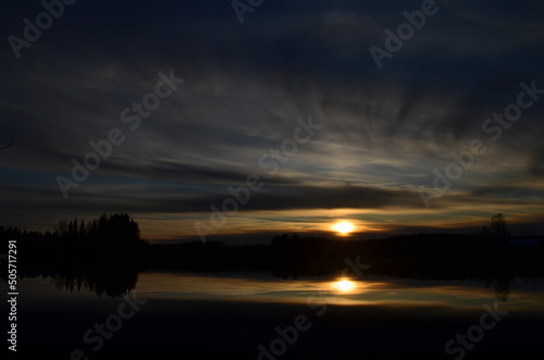 Fototapeta Naklejka Na Ścianę i Meble -  sunset over the lake, reflection of the forest at sunset, sunset on the forest lake, Finnish nature through the eyes of a Refugee