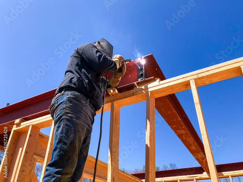 framing construction, welder welding metal beam