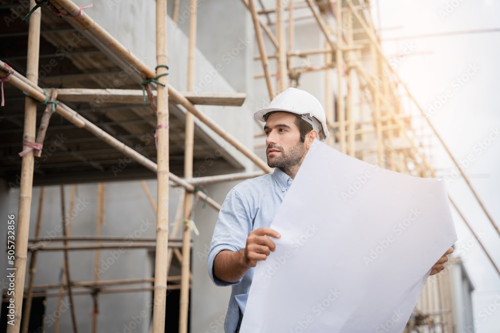 Young male engineers standing on the construction site to check the various functions.